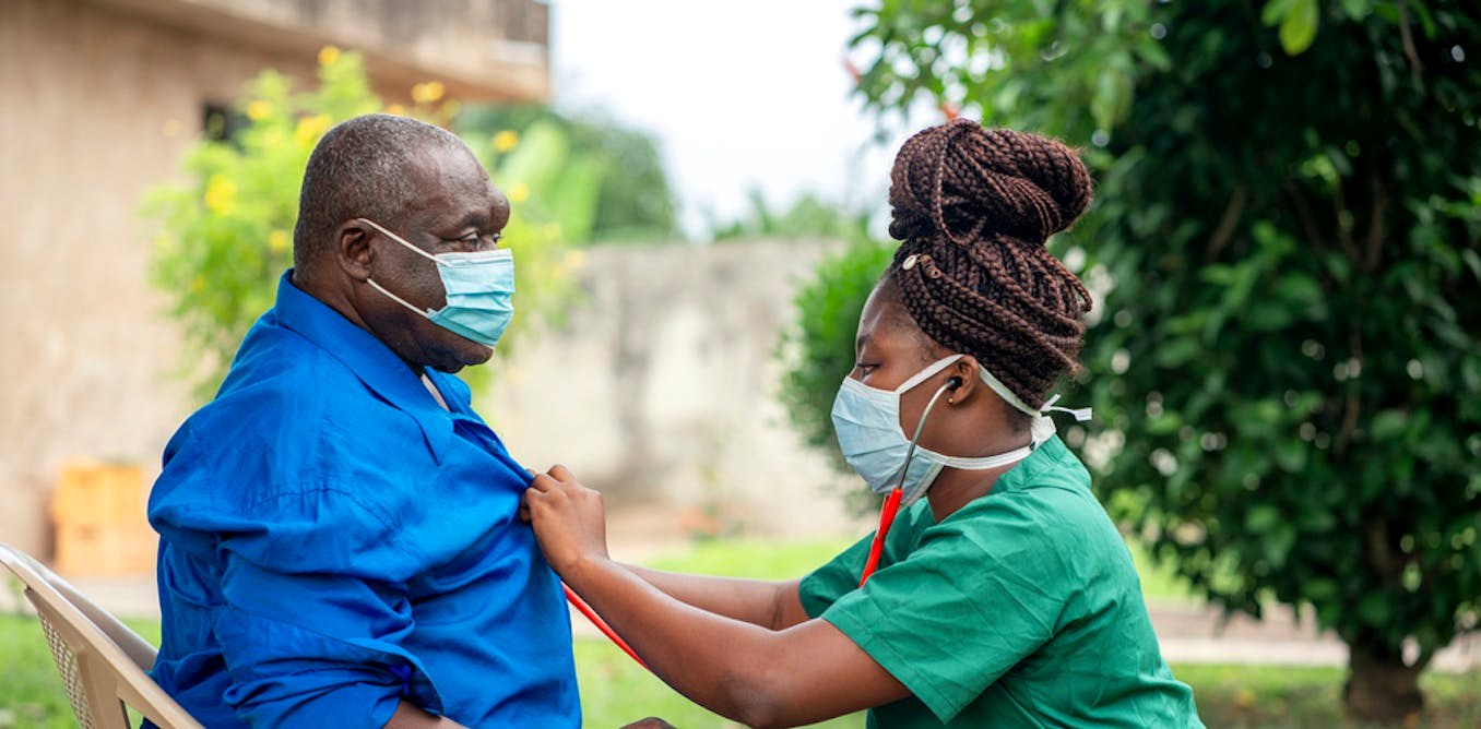 Family nurse supporting a client outdoors.