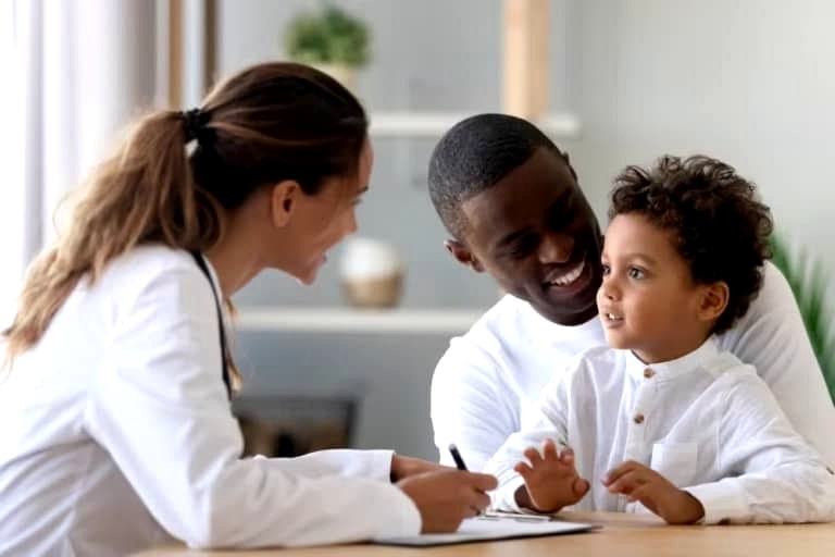 Family nurse or midwife supporting a parent and child.
